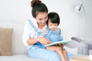 Asian-mother-reading-to-daughter