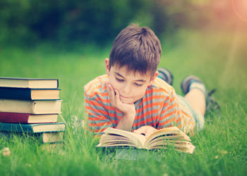 Boy-reading-outdoors