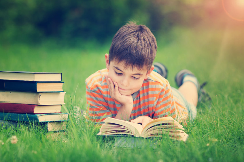 Boy-reading-outdoors
